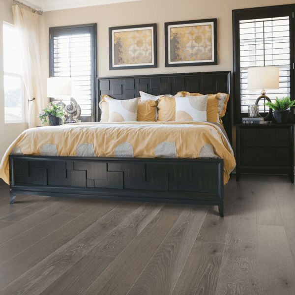A bedroom with a bed and two nightstands.