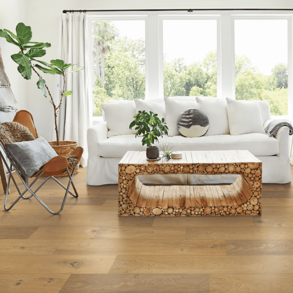 A living room with a couch, chair and table.
