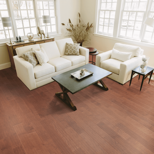 A living room with white furniture and wood floors.