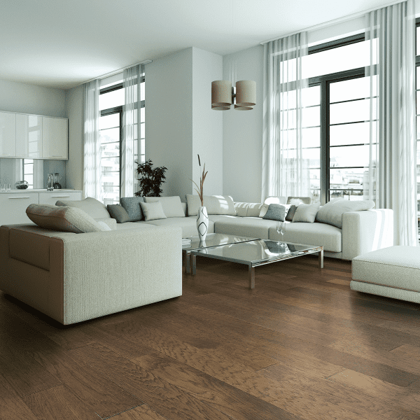 A living room with white furniture and large windows.