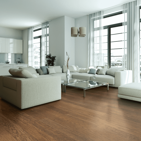 A living room with white furniture and large windows.