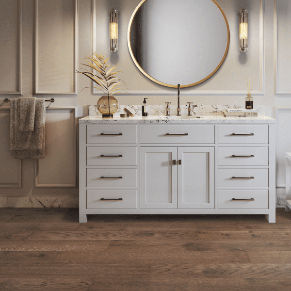 A bathroom with white cabinets and a large mirror.
