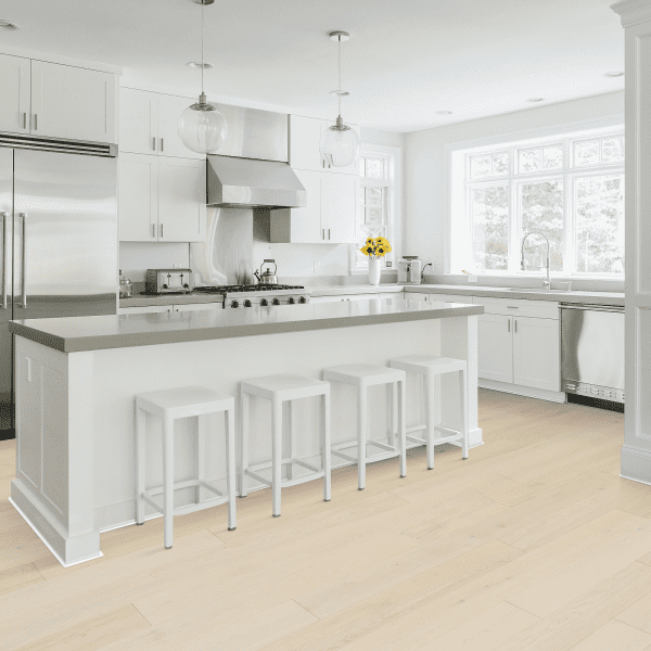 A kitchen with white cabinets and stainless steel appliances.