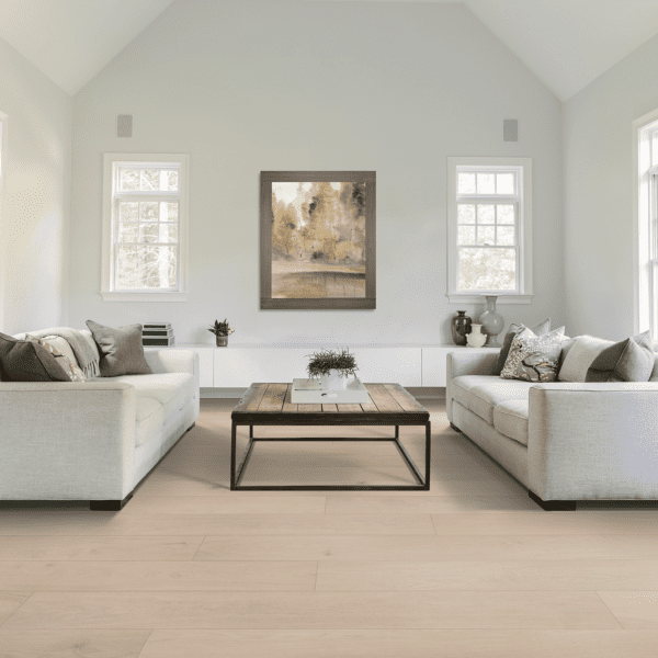 A living room with white couches and a coffee table.