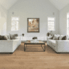 A living room with white couches and a coffee table.