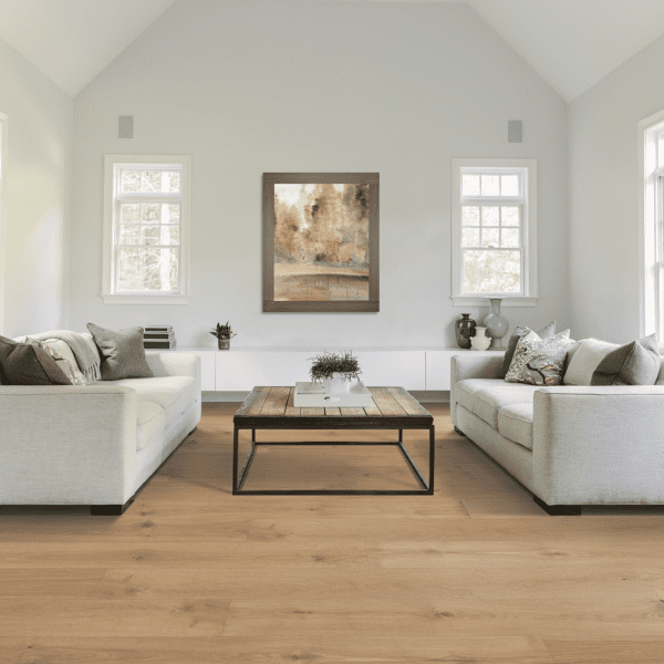 A living room with white couches and a coffee table.