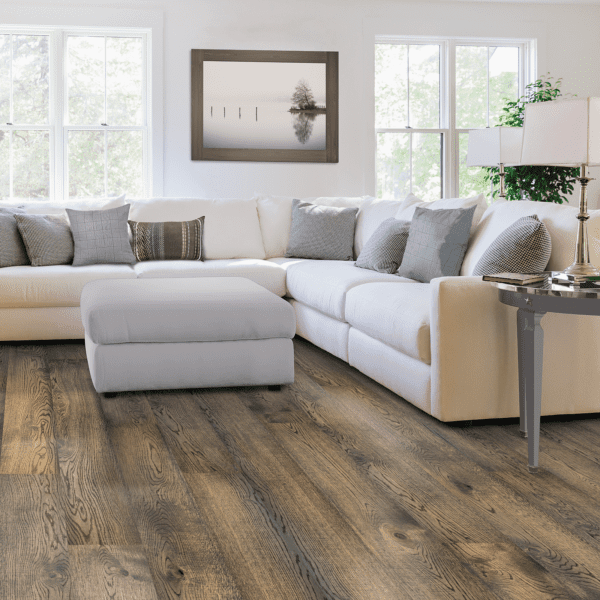 A living room with white furniture and wood floors.