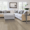 A living room with white furniture and wood floors.