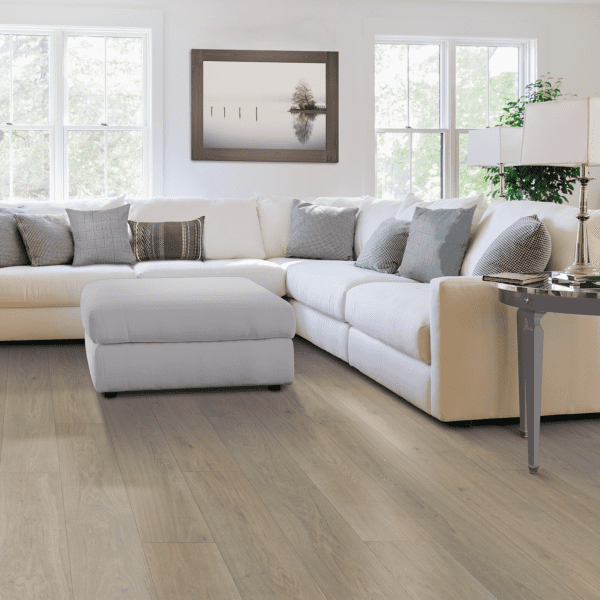 A living room with white furniture and wood floors.