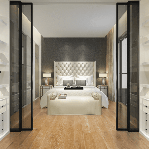 A bedroom with a bed and two nightstands.
