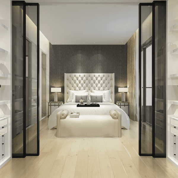 A bedroom with a bed and two nightstands.