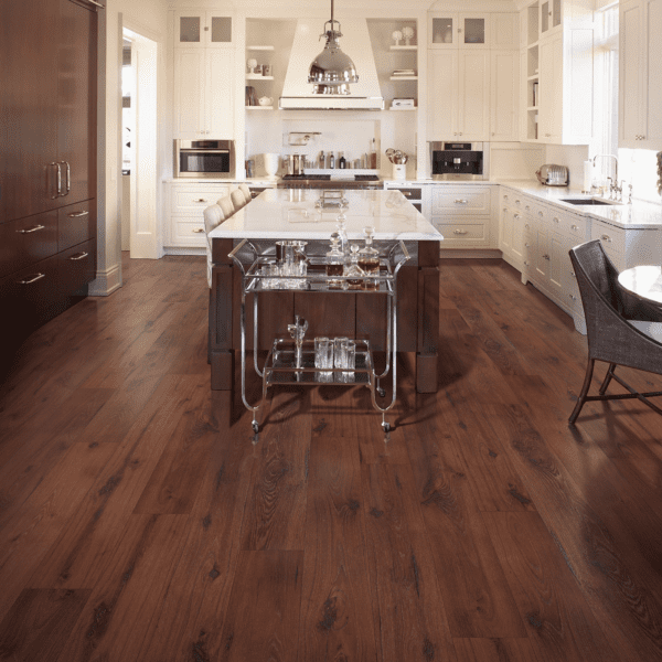 A kitchen with wood floors and white cabinets.