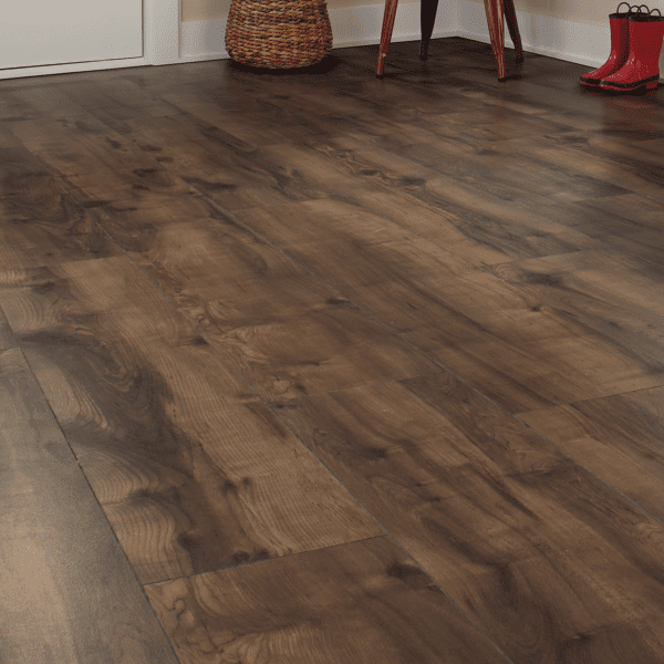 A wooden floor with a red boot on the ground.