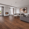A living room with wood floors and grey couches.