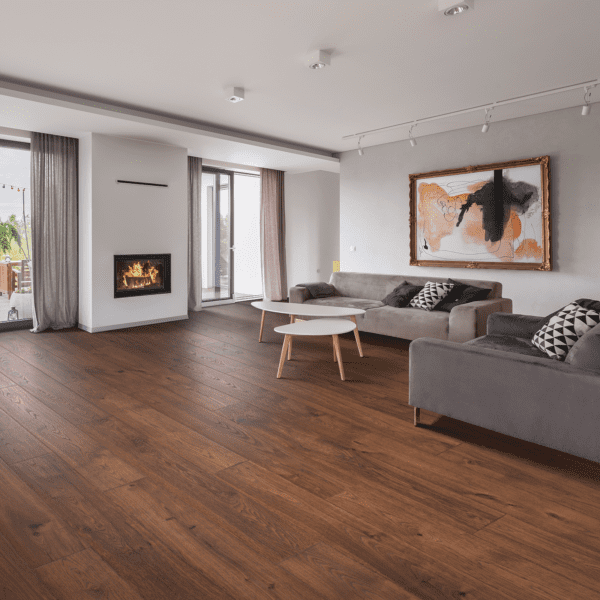 A living room with wood floors and grey couches.