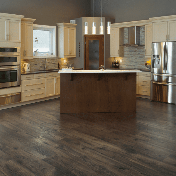 A kitchen with wood floors and stainless steel appliances.