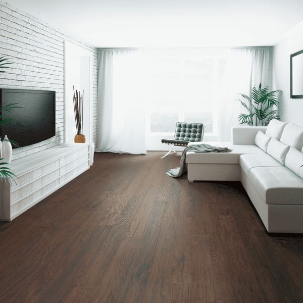 A living room with white furniture and wood floors.