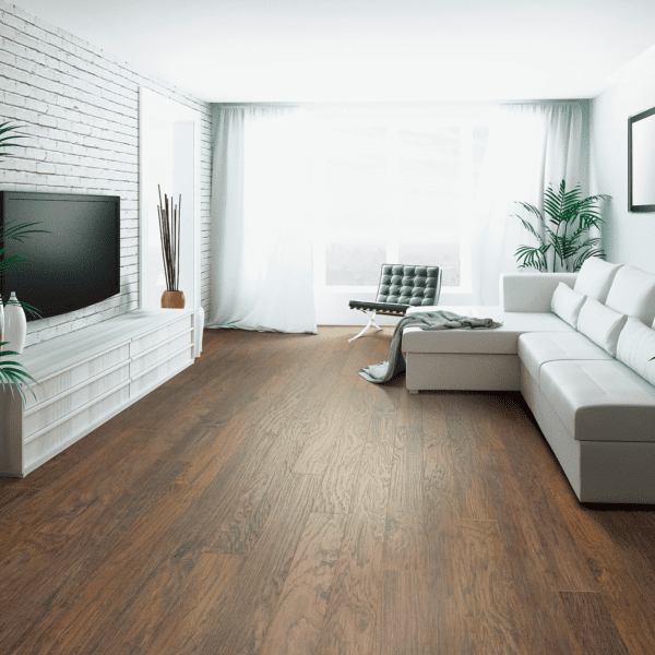 A living room with white furniture and wood floors.
