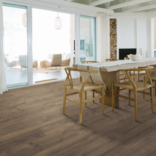 A dining room with wooden furniture and sliding glass doors.