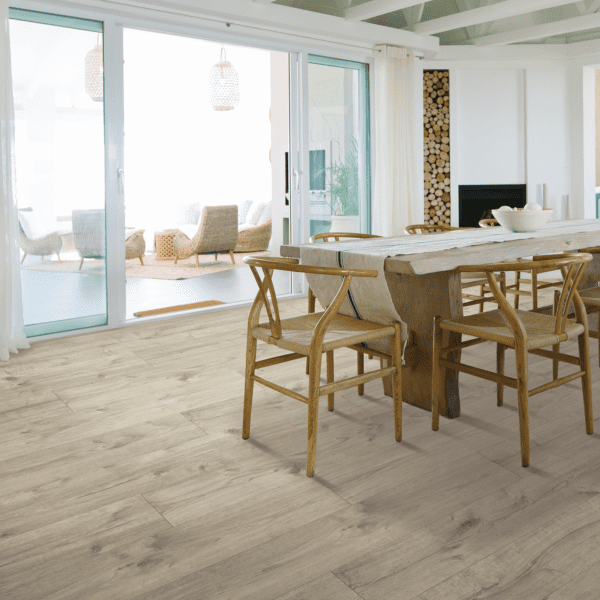 A dining room with wooden furniture and sliding glass doors.