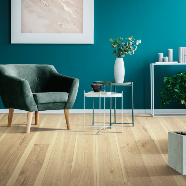 A living room with blue walls and green furniture.