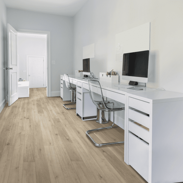 A room with two desks and a chair.