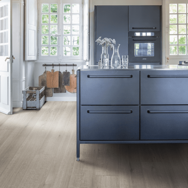 A kitchen with blue cabinets and white counters.