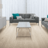 A living room with grey furniture and white curtains.