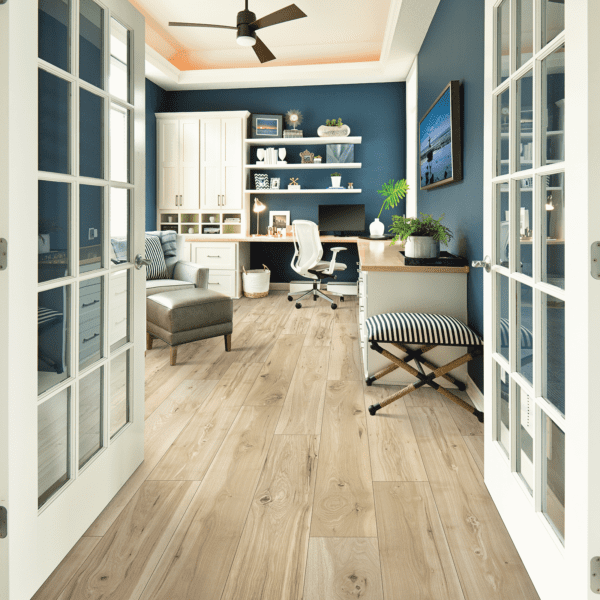 A room with two doors and a desk in it.