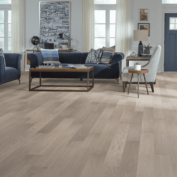 A living room with hard wood floors and furniture.