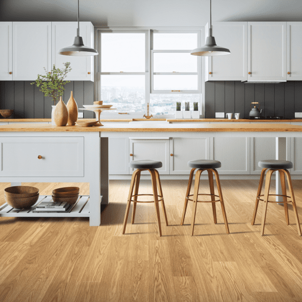 A kitchen with wooden floors and white cabinets.