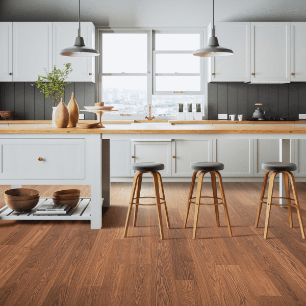 A kitchen with wooden floors and white cabinets.