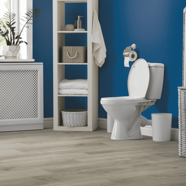 A bathroom with blue walls and white fixtures.
