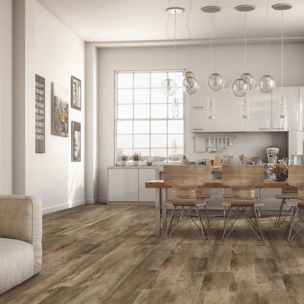 A dining room with a table and chairs, and a kitchen.