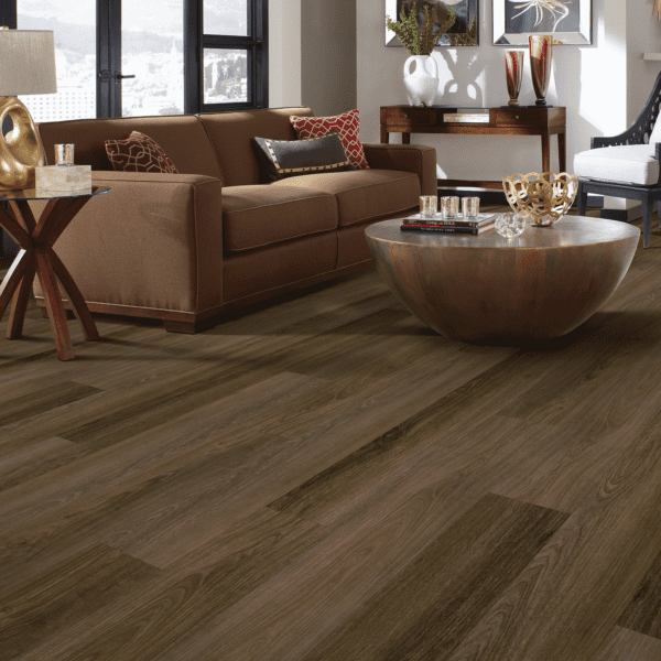 A living room with brown walls and wooden floors.