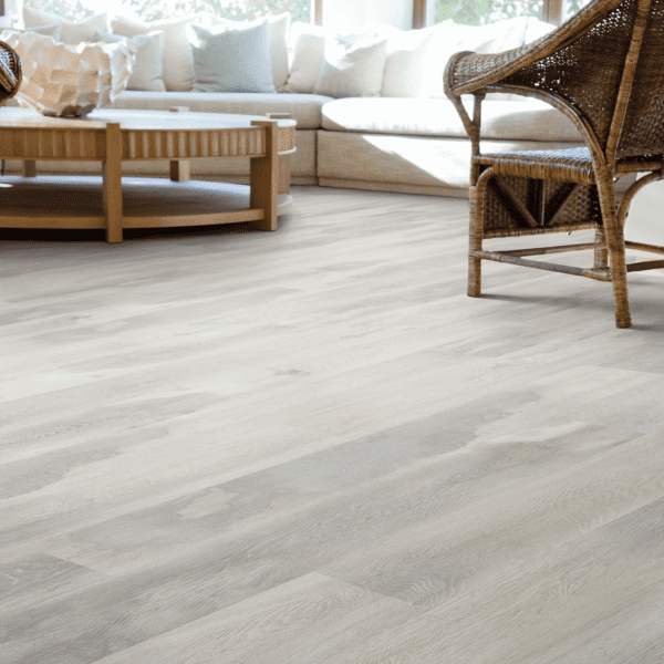 A living room with white walls and wooden floors.
