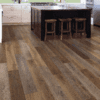 A kitchen with wood flooring and a counter.