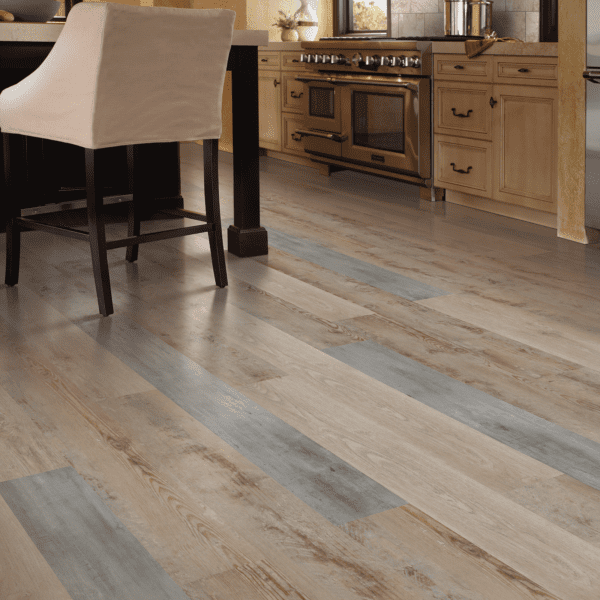 A kitchen with wood floors and a chair.