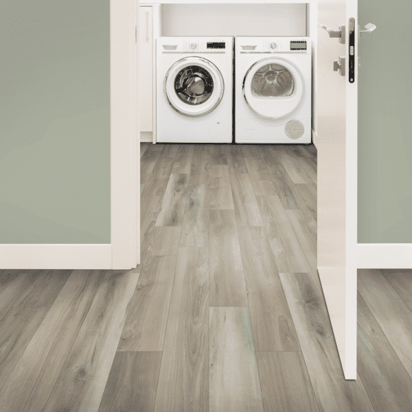 A view of two laundry machines from the doorway.