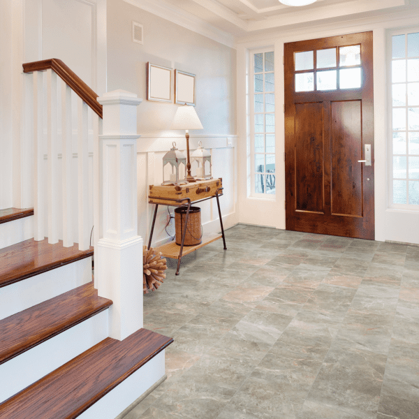 A foyer with stairs and a door leading to the second floor.