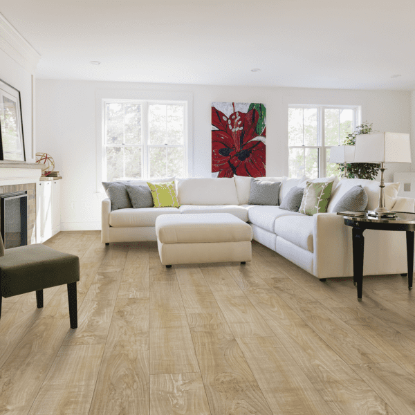 A living room with white furniture and wood floors.