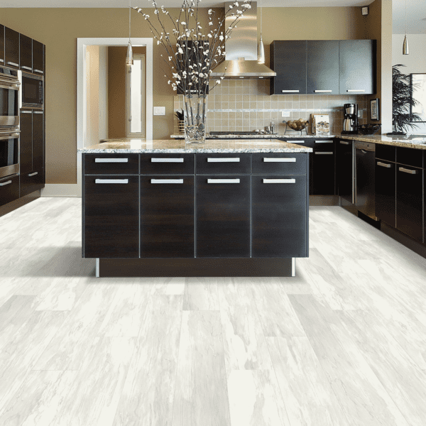 A kitchen with black cabinets and white walls.