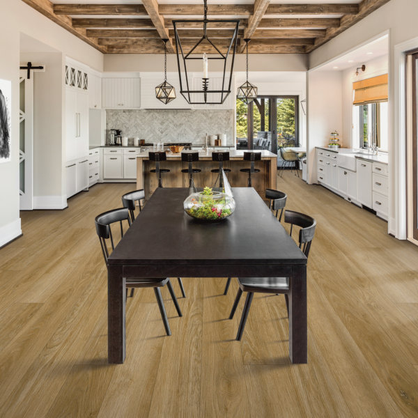 A large dining room with wooden floors and white walls.