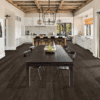 A kitchen with dark wood floors and white walls.