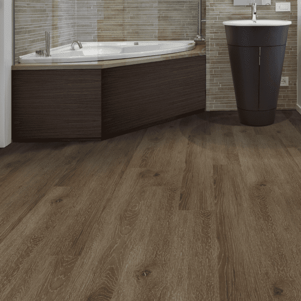 A bathroom with wood floors and a tub.
