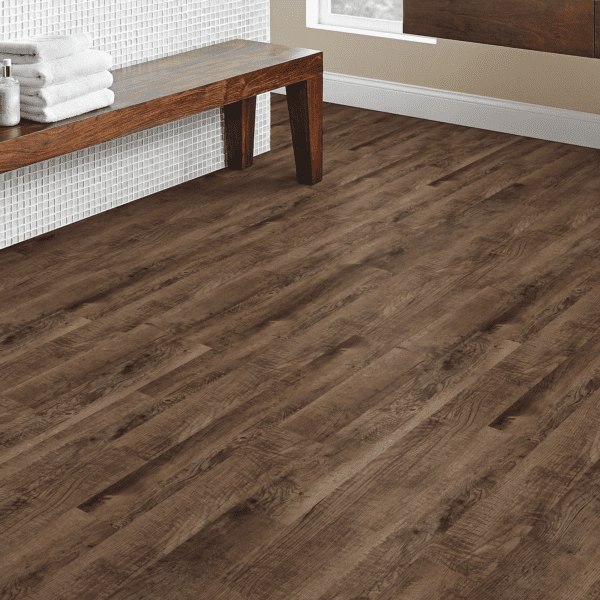 A room with wooden floors and a bench.
