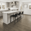 A kitchen with an island and black chairs.