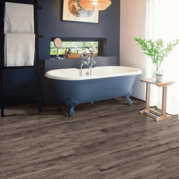 A bathroom with a tub and blue walls.