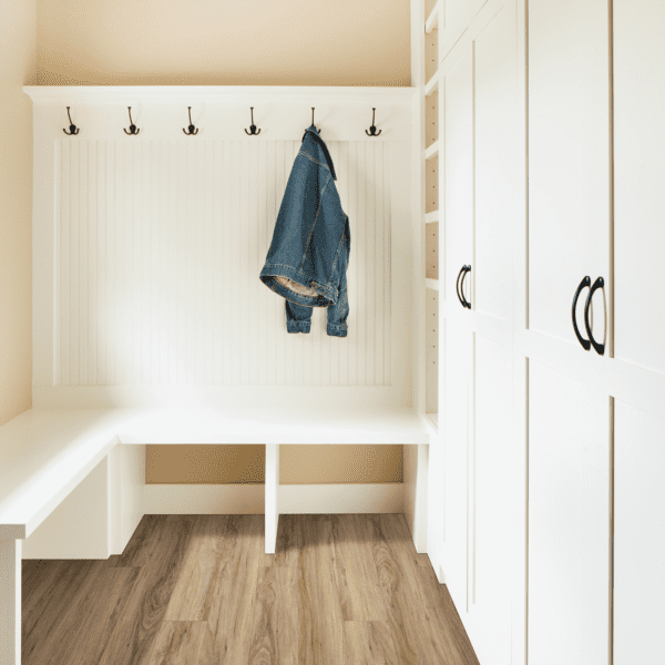 A white room with a bench and coat rack.