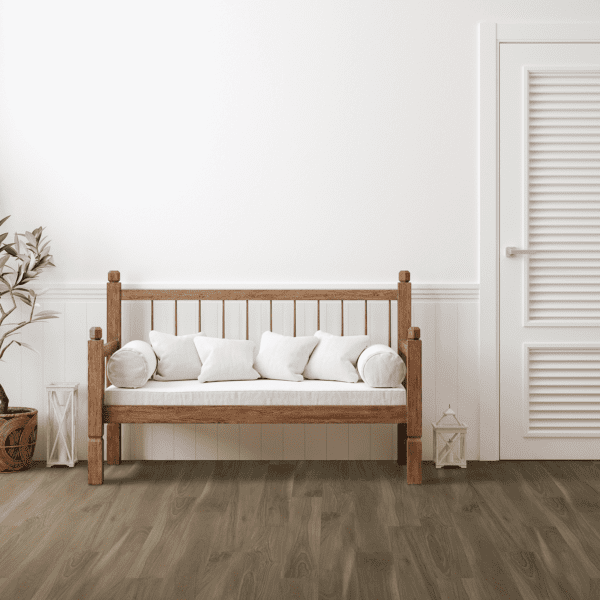 A wooden bench with pillows in front of a white door.